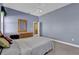 Bedroom with blue painted walls, carpet floors, dresser and doorway to the Primary bath at 4823 Deer Lodge Rd, New Port Richey, FL 34655