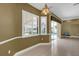 Dining area featuring a large window with plantation shutters and sliding glass doors to the pool area at 4823 Deer Lodge Rd, New Port Richey, FL 34655