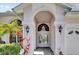 Close up of the front entrance featuring a brick facade and leaded glass double doors at 4823 Deer Lodge Rd, New Port Richey, FL 34655