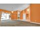 Open-concept living room with decorative lighting, bright paint, and access to outdoor living space at 4823 Deer Lodge Rd, New Port Richey, FL 34655