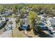 Aerial view of the blue home, lush greenery, and neighborhood at 502 W Hanna Ave, Tampa, FL 33604