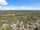Wide aerial view featuring river and tree coverage with neighborhood homes and sunny skies at 502 W Hanna Ave, Tampa, FL 33604