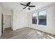 Bright bedroom features wood-look flooring, closet, and ceiling fan at 502 W Hanna Ave, Tampa, FL 33604