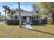 Attractive blue home with well-kept landscaping and a inviting front entrance at 502 W Hanna Ave, Tampa, FL 33604