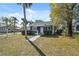 Charming blue home featuring neat landscaping and an inviting front porch at 502 W Hanna Ave, Tampa, FL 33604