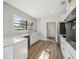Bright kitchen featuring quartz countertops, stainless appliances, white cabinetry and hardwood floors at 502 W Hanna Ave, Tampa, FL 33604