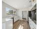 Modern white kitchen with stainless steel appliances, white countertops, and designer backsplash at 502 W Hanna Ave, Tampa, FL 33604