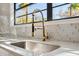 Kitchen faucet with quartz countertops and tile backsplash at 502 W Hanna Ave, Tampa, FL 33604