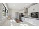 Bright kitchen with white cabinets, quartz counters and gold hardware at 502 W Hanna Ave, Tampa, FL 33604