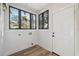 Bright laundry room with wood-look flooring, white walls, and natural lighting at 502 W Hanna Ave, Tampa, FL 33604