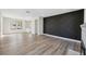 Bright living room with wood-look floors and a stylish decorative wall at 502 W Hanna Ave, Tampa, FL 33604