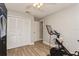 Bedroom with double closet, Peloton exercise bike, and light gray colored walls with white trim at 5441 Worthington Loop, Palm Harbor, FL 34685
