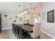 Formal dining room features a dark wood table, elegant chandelier, and decorative wall accents at 5441 Worthington Loop, Palm Harbor, FL 34685