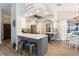 Open-concept living space with a breakfast bar, stainless steel appliances, and wood-look tile flooring at 5441 Worthington Loop, Palm Harbor, FL 34685