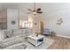 Cozy living room with wood-look tile flooring, natural light, and comfortable seating at 5441 Worthington Loop, Palm Harbor, FL 34685