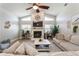 Bright living room featuring a fireplace with large windows, high ceilings, and wood-style flooring at 5441 Worthington Loop, Palm Harbor, FL 34685