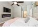 Main bedroom features modern electric fireplace, TV, and en-suite bathroom access at 5441 Worthington Loop, Palm Harbor, FL 34685