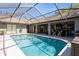 Beautiful backyard pool with screened enclosure and outdoor seating, perfect for entertaining and relaxation at 5441 Worthington Loop, Palm Harbor, FL 34685