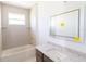 Contemporary bathroom with a soaking tub, a dark vanity, a granite countertop, and modern, illuminated mirror at 59 Mark Twain Ln, Rotonda West, FL 33947