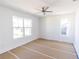 Spacious bedroom with a ceiling fan, white trim, and two large windows at 59 Mark Twain Ln, Rotonda West, FL 33947