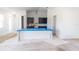 Spacious kitchen featuring dark cabinets, a large island with protective covering, and bright, natural light at 59 Mark Twain Ln, Rotonda West, FL 33947