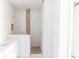 Modern bathroom with a tiled shower featuring pebble accents, a built-in niche, and a clean, minimalist design at 59 Mark Twain Ln, Rotonda West, FL 33947