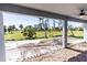 Covered patio with serene views of the lush backyard and a ceiling fan at 59 Mark Twain Ln, Rotonda West, FL 33947