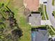 Aerial view showcasing the property's layout, including the screened pool and proximity to the neighborhood at 7309 Night Heron Dr, Land O Lakes, FL 34637
