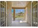 Small covered balcony with stucco walls, white railings, and a view of the lush green landscape at 7309 Night Heron Dr, Land O Lakes, FL 34637