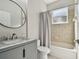 Bathroom with a gray vanity and a tub with tile surround and shower at 7309 Night Heron Dr, Land O Lakes, FL 34637