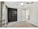 Bedroom featuring neutral carpet, ceiling fan, and a built-in bookshelf at 7309 Night Heron Dr, Land O Lakes, FL 34637