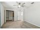 The bedroom has carpet, a fan, and closet with storage at 7309 Night Heron Dr, Land O Lakes, FL 34637