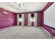 Carpeted media room with movie screen, dual windows with curtains, and ceiling fan and projector at 7309 Night Heron Dr, Land O Lakes, FL 34637