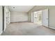 Large bedroom features plush carpet, neutral walls, and double doors leading to a bathroom and the hallway at 7309 Night Heron Dr, Land O Lakes, FL 34637