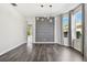 Dining area with hardwood floors, chandelier lighting, and a neutral accent wall with modern artwork at 7309 Night Heron Dr, Land O Lakes, FL 34637