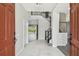 Elegant foyer with soaring ceilings, chandelier, and staircase leading to the second floor at 7309 Night Heron Dr, Land O Lakes, FL 34637