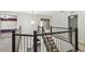 Upstairs landing showcasing railing, chandelier, and access to various rooms at 7309 Night Heron Dr, Land O Lakes, FL 34637