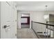 Bright upstairs hallway with railing and views into the adjacent entertainment room at 7309 Night Heron Dr, Land O Lakes, FL 34637