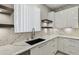 Bright kitchen with marble countertops, white cabinetry, and stainless steel appliances at 7309 Night Heron Dr, Land O Lakes, FL 34637