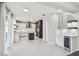 Modern kitchen with sleek white cabinets, stainless steel appliances, and a wine cooler at 7309 Night Heron Dr, Land O Lakes, FL 34637