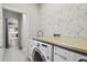 Chic laundry room with butcher block countertop and modern appliances at 7309 Night Heron Dr, Land O Lakes, FL 34637