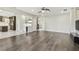 Open-concept living space featuring hardwood floors, modern lighting, and seamless flow to the kitchen at 7309 Night Heron Dr, Land O Lakes, FL 34637