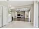 Bright, open-concept living area with hardwood floors, modern lighting, and access to the kitchen with a wine cooler at 7309 Night Heron Dr, Land O Lakes, FL 34637