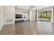 Bright and airy living room features hardwood floors, fireplace, and access to the outdoor patio at 7309 Night Heron Dr, Land O Lakes, FL 34637