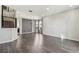 Spacious living room with hardwood floors, modern lighting, and staircase at 7309 Night Heron Dr, Land O Lakes, FL 34637
