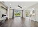 Bright living room featuring hardwood floors, modern fireplace and large windows to the outdoor area at 7309 Night Heron Dr, Land O Lakes, FL 34637