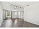 Open-concept living room featuring a modern chandelier and hardwood floors at 7309 Night Heron Dr, Land O Lakes, FL 34637