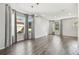 An elegant living room with hardwood floors, geometric accent wall, and large windows with stylish curtains at 7309 Night Heron Dr, Land O Lakes, FL 34637