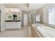 Large main bathroom features a soaking tub, glass shower, double vanity, and access to the Primary bedroom at 7309 Night Heron Dr, Land O Lakes, FL 34637
