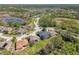Aerial view of the neighborhood featuring tree-lined streets and community lakes at 7309 Night Heron Dr, Land O Lakes, FL 34637